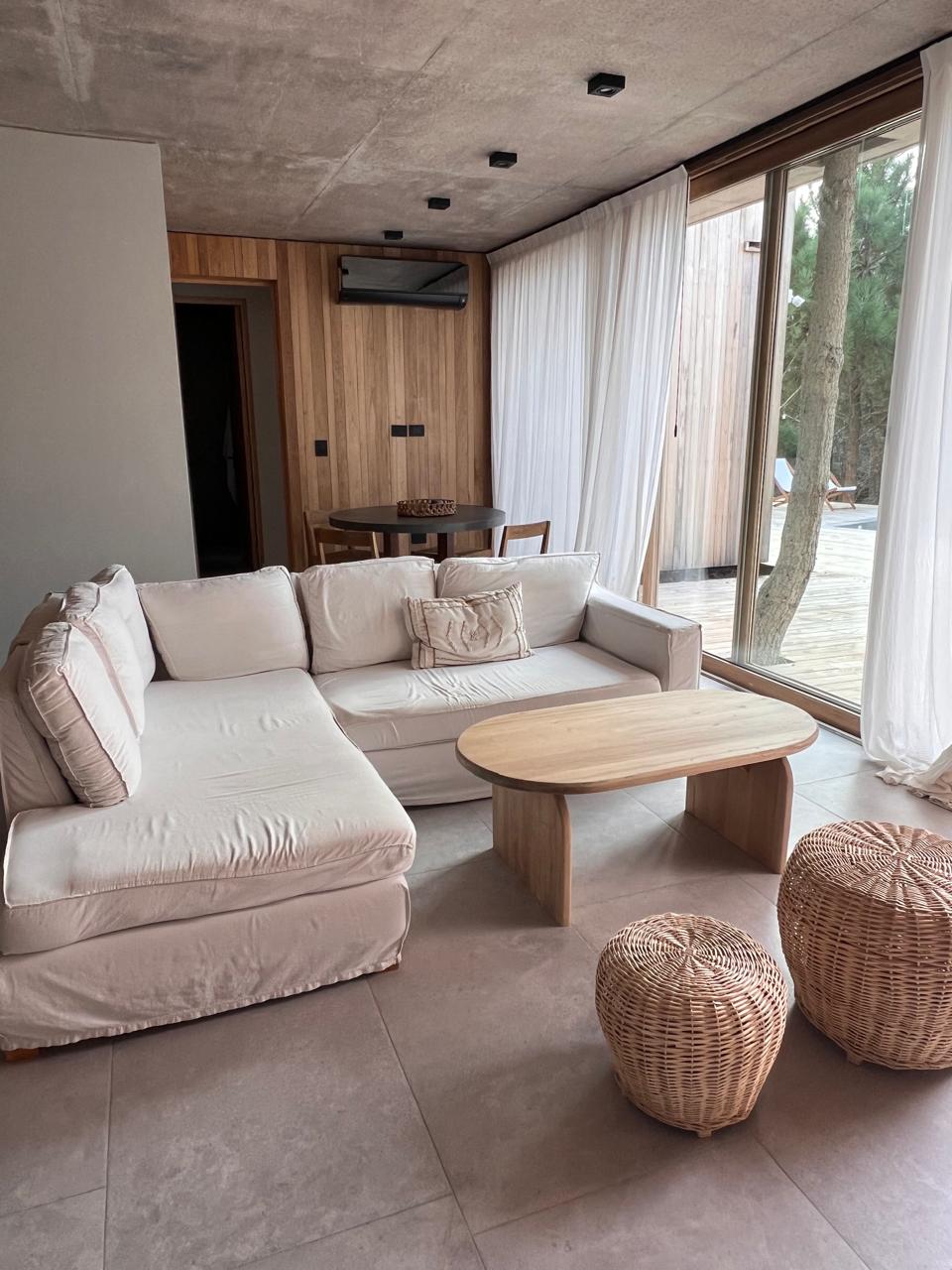 Cortinados sheer en living con puertas al jardín y pinos